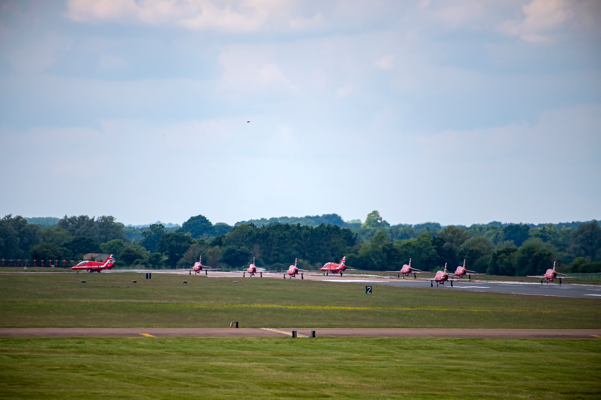 Hawk T1 aircraft assigned to the Royal Air Force aerobatic team, known as the Red Arrows, taxi on the runway at RAF Fairford, England, June 2, 2022. The Red Arrows landed at Fairford to refuel in preparation for the Queen’s Platinum Jubilee Ceremonies and Midlands Air Festival. (U.S. Air Force photo by Staff Sgt. Eugene Oliver)