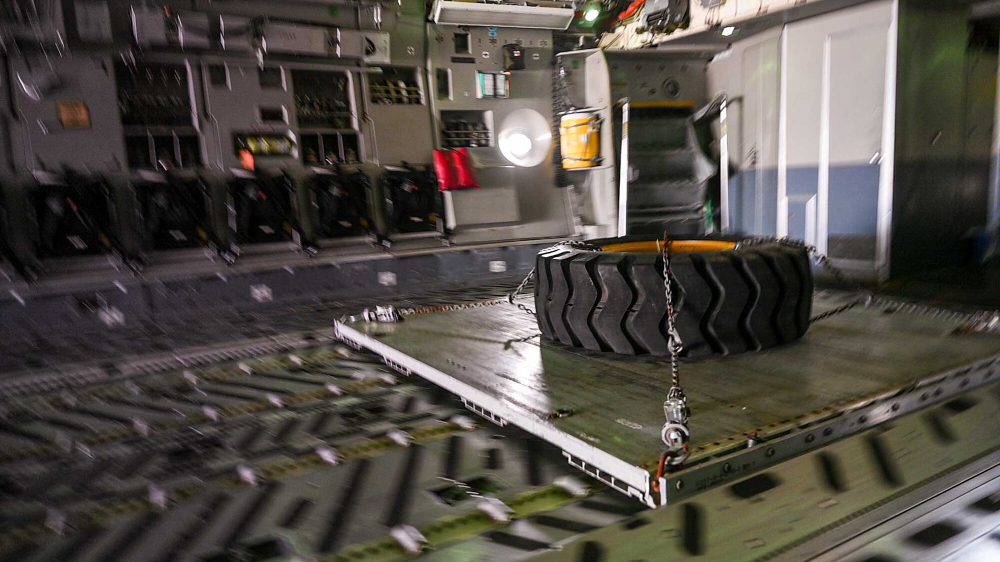 A palletized tire moves during a combat offload on a C-17 Globemaster III during a local training mission at Dover Air Force Base, Delaware, May 24, 2022. The tire pallet is used for combat offload exercises to maintain the readiness of 3rd Airlift Squadron Airmen who regularly train to provide global reach and support global engagement with time-critical theater assets. (U.S. Air Force photo by Senior Airman Faith Schaefer)