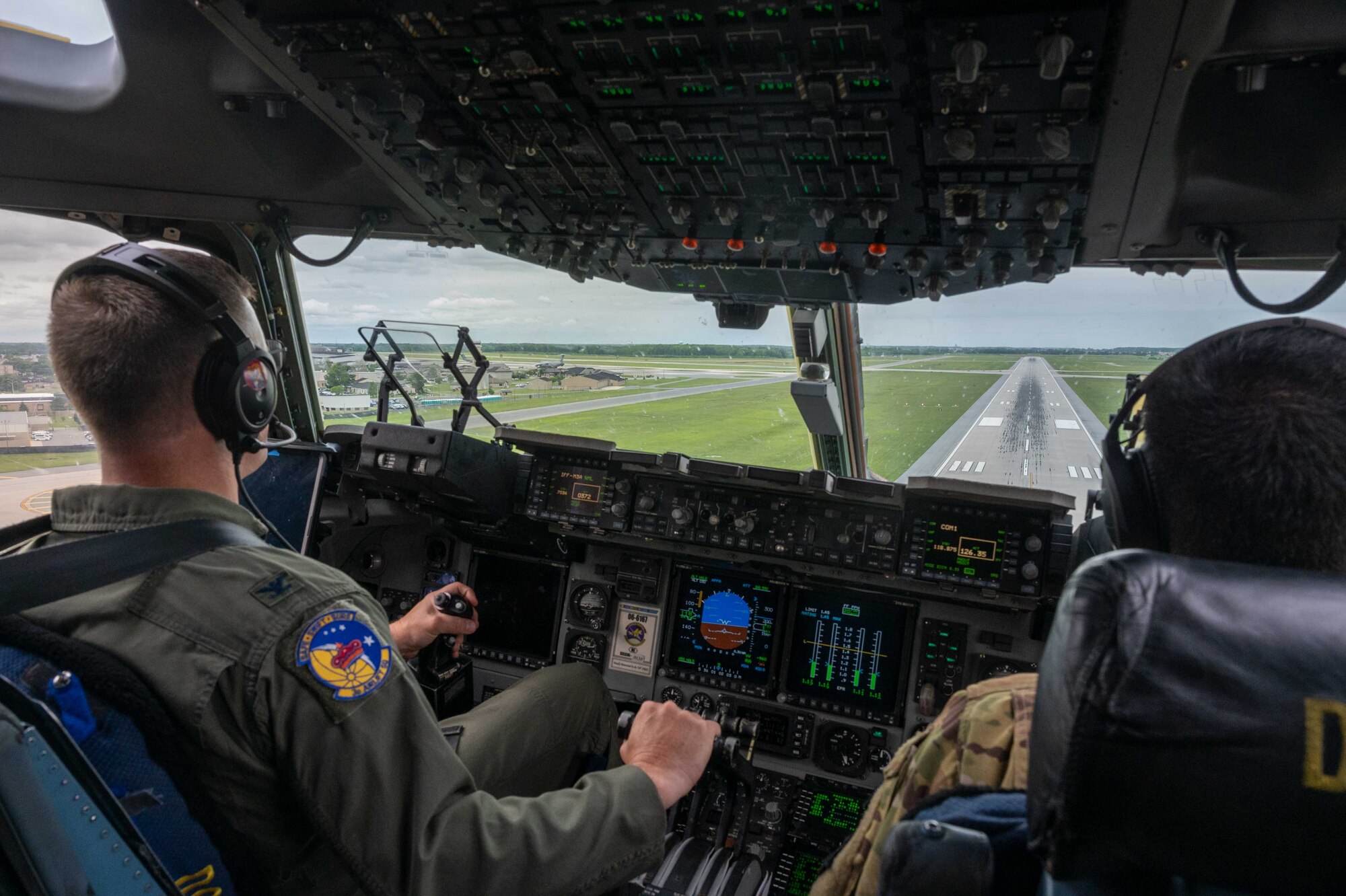 Col. Scott Raleigh, left, 436th Operations Group commander, and 1st Lt. Milton Doria, 3rd Airlift Squadron pilot, prepare to land a C-17 Globemaster III during a local training mission at Dover Air Force Base, Delaware, May 24, 2022. The 3rd AS regularly trains to provide global reach and support global engagement. (U.S. Air Force photo by Senior Airman Faith Schaefer)