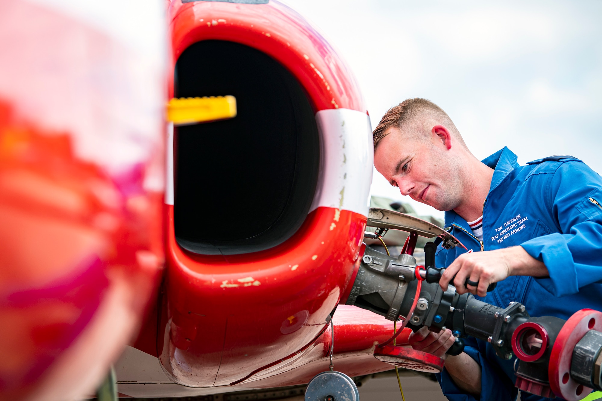 Royal Air Force Corporal Tom Davidson, Red Arrows engineering technician, refules a Hawk T1 aircraft at RAF Fairford, England, June 2, 2022. The Red Arrows landed at Fairford to refuel in preparation for the Queen’s Platinum Jubilee Ceremonies and Midlands Air Festival. (U.S. Air Force photo by Staff Sgt. Eugene Oliver)