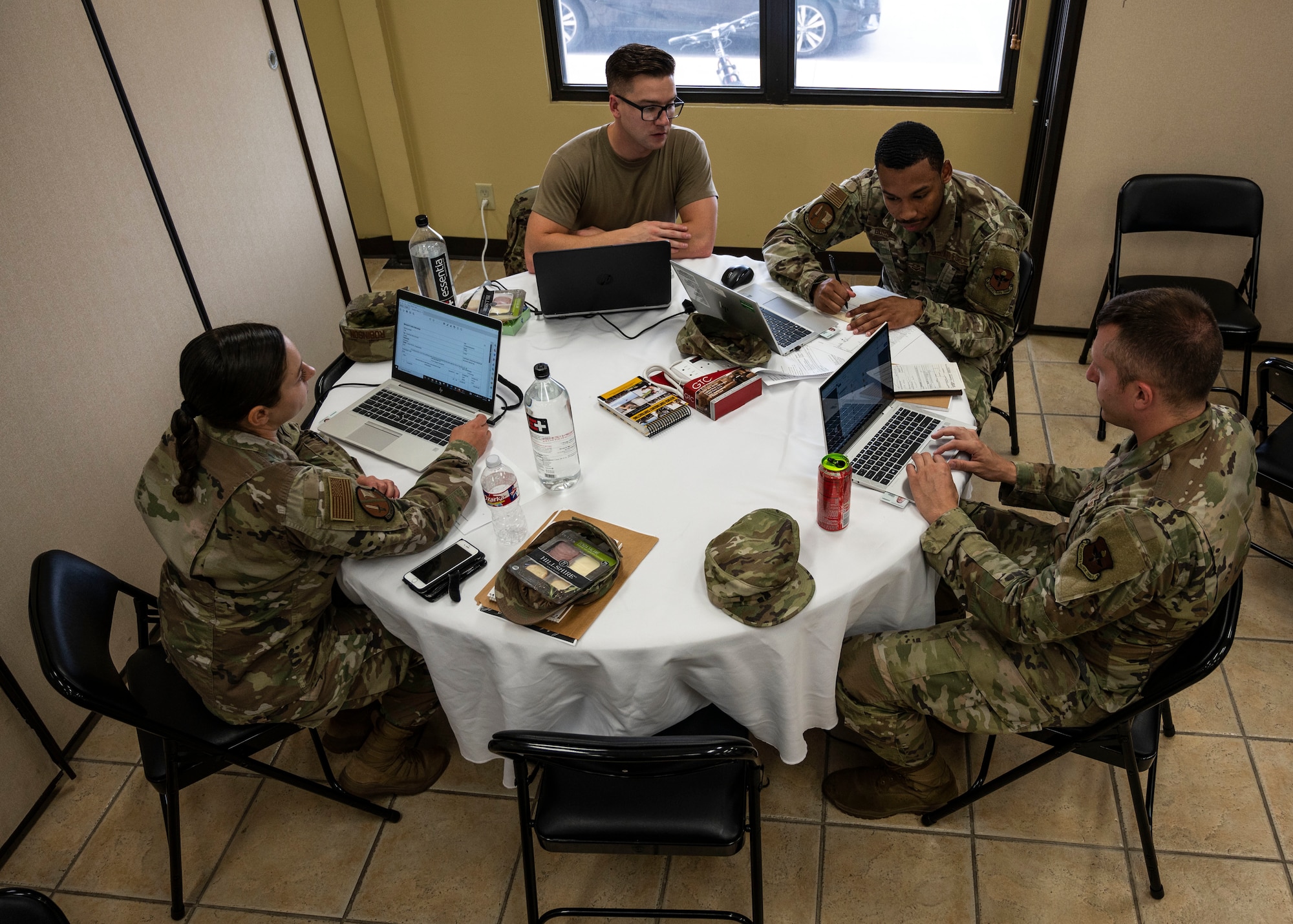 Members of the 47th Contracting Flight work as a team to solve an exercise scenario during a contingency contracting officer exercise June 2, 2022, at Laughlin Air Force Base, Texas.