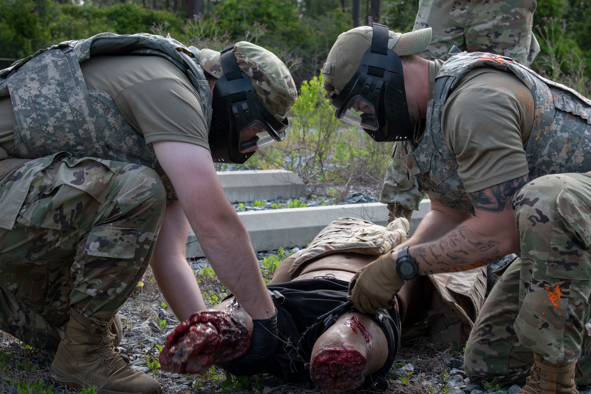 U.S. Air Force Staff Sgt. Austin Yentes, the 1st Special Operations Healthcare Operations Squadron information systems NCOIC, left, and U.S. Air Force Staff Sgt. Randal Marks, the 1st SOHCOS hematology NCOIC, right, provide medical care for a SIM Manikin during a tactical combat casualty care training April 29, 2022, at Hurlburt Field, Florida.