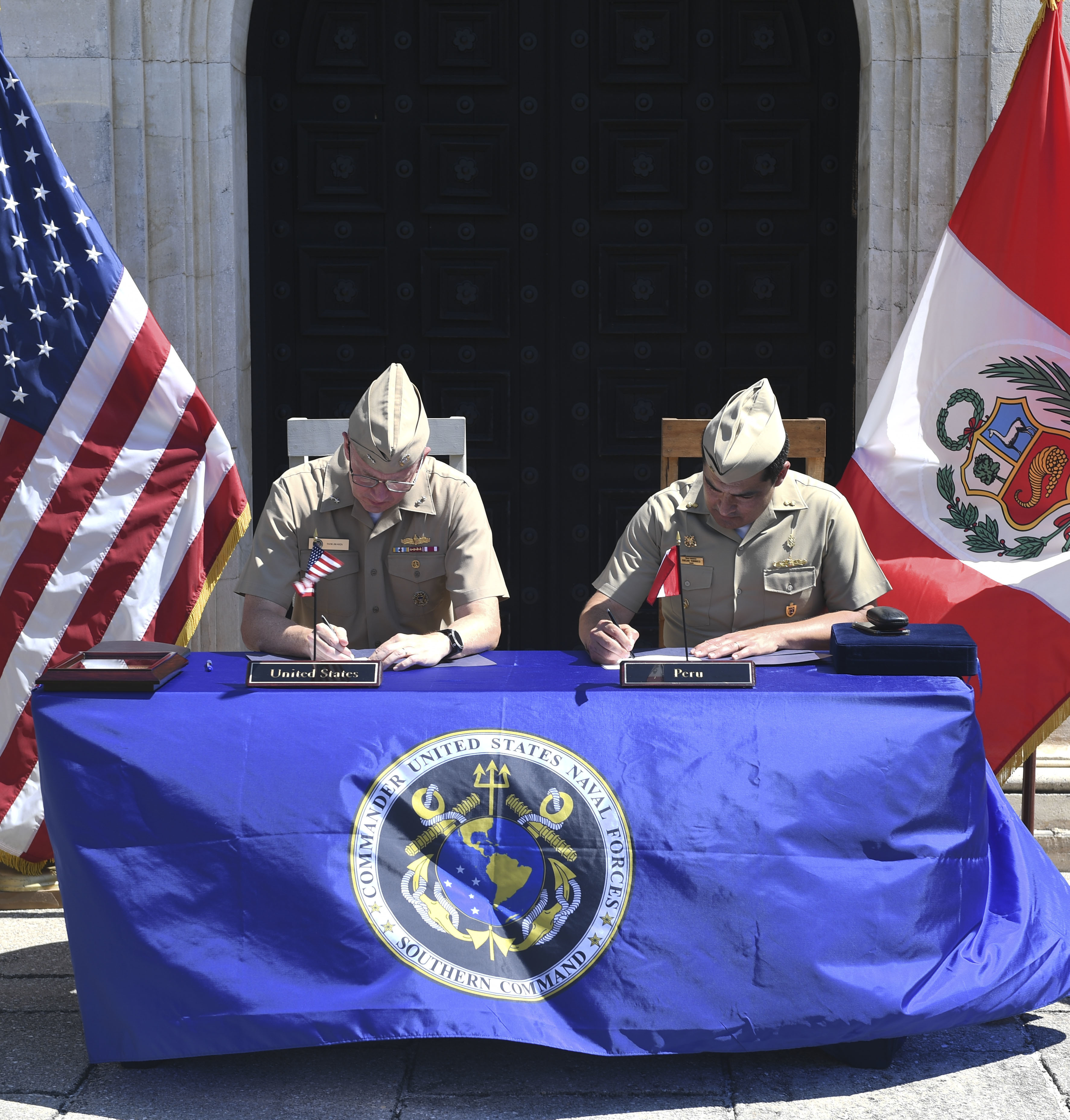 Rear Adm. Jim Aiken, Commander, U.S. Naval Forces Southern Command/U.S. 4th Fleet, left, signs the minutes with Peruvian navy Rear Adm. Oscar Torrico, Deputy Chief of Naval General Staff, at the closing ceremony of the 28th annual Maritime Staff Talks (MST), June 3, 2022.