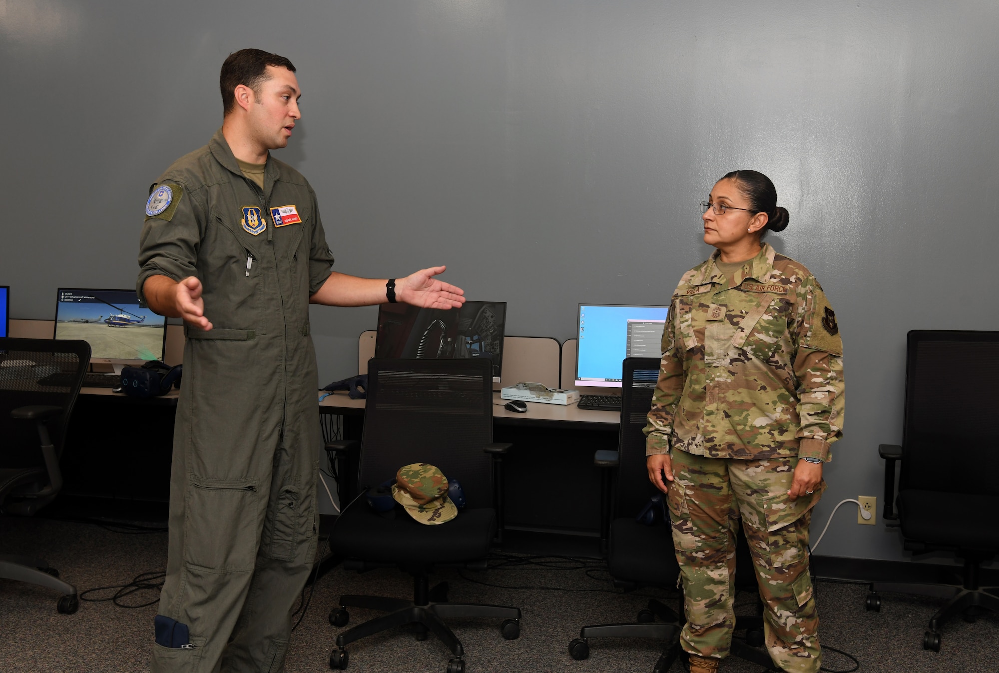 Master Sgt. Jason Henry, 733rd Training Squadron flight engineer instructor, talks with Chief Master Sgt. Cynthia Villa, 4th Air Force command chief, about the virtual reality training lab capabilities at the Career Enlisted Aviator Center of Excellence, Joint Base San Antonio-Lackland, Texas, June 3, 2022. Villa visited the 433rd Airlift Wing to learn more about the mission and the unit’s successes and challenges. (U.S. Air Force photo by Kristian Carter)