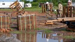 Two dozen Airmen from the 124th Civil Engineer Squadron, Idaho Air National Guard, build pallet bridges to access new homes during an innovative readiness project in the Cherokee Nation, Tahlequah, Oklahoma.