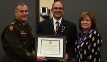 Gen. James Dickinson, commander of U.S. Space Command, presents a certificate of retirement to Thomas Webber, director of the U.S. Army Space and Missile Defense Command Technical Center, alongside Webber’s wife, Debbie. Webber retires after more than 30 years of combined federal service. (U.S. Army photo by Ayumi Davis)
