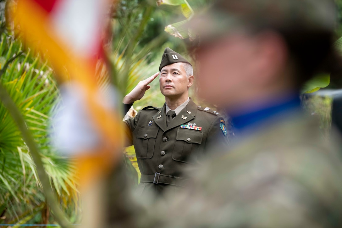 An Army captain salutes during a ceremony.