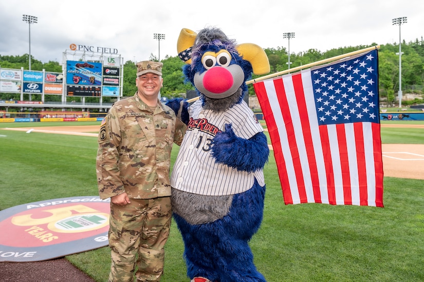 Photo of SSG Warner with SWB Railriders mascot Champ.