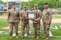 Photo of from left: Depot Commander Col. Daniel L. Horn, Lt. Steven Servano, SSG Warner, and Depot Sergeant Major Michael J. Wiles.