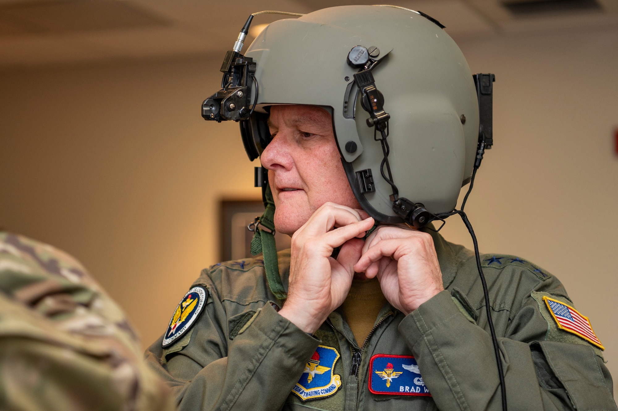 U.S. Air Force Lt. Gen. Brad Webb, commander of Air Education and Training Command, straps on his helmet prior to conducting his fini-flight May 10, 2022 at Hurlburt Field, Fla.