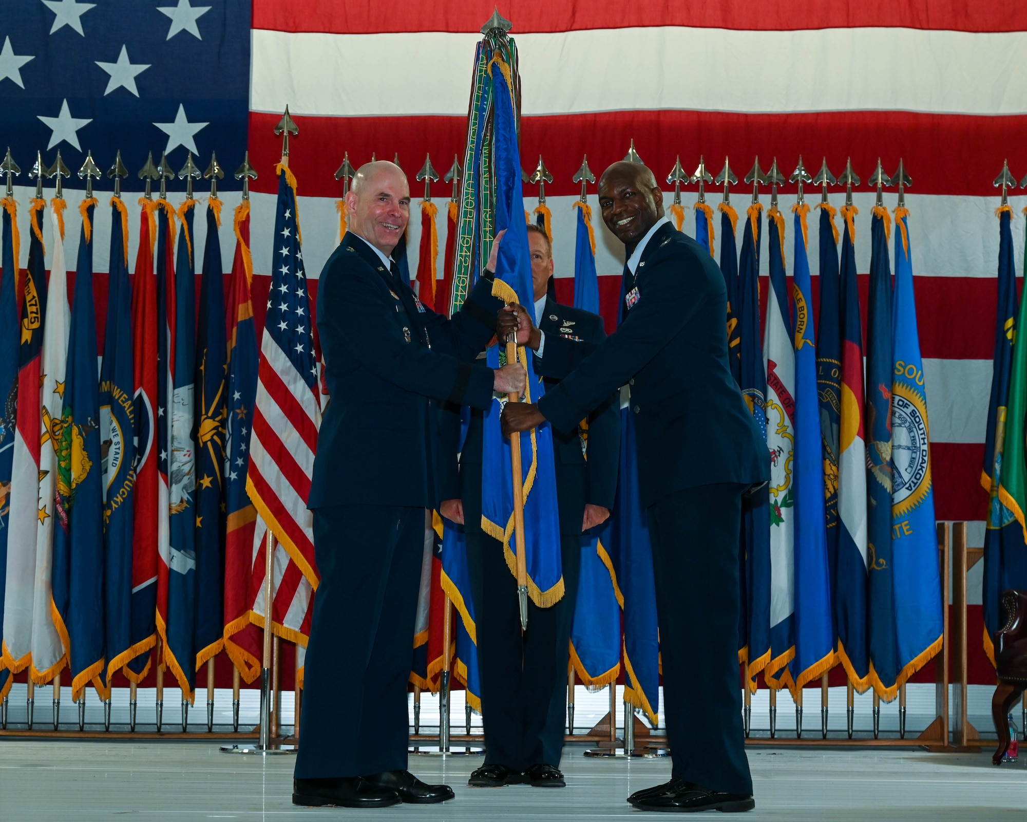 Col. Kenneth McGhee, incoming 91st Missile Wing commander, receives the guidon from Maj. Gen. Michael Lutton, 20th Air Force commander at Minot Air Force Base, North Dakota, June 06, 2022. Prior to taking command of the 91st Missile Wing, McGee was commander of the 341st Operations group at Malmstrom Air Force Base, Montana. (U.S. Air Force photo by Airman 1st Class Evan Lichtenhan)