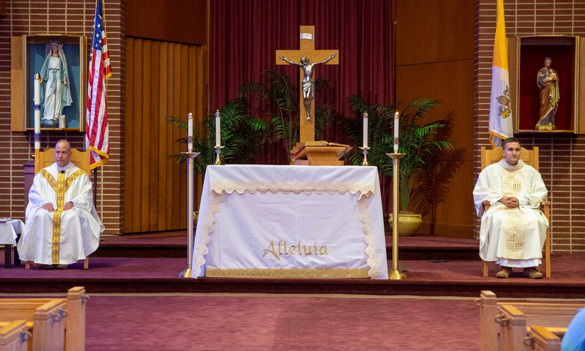 Chaplain Michal Falgowski, right, conducts Catholic Mass at Joint Base McGuire-Dix-Lakehurst, New Jersey, May 15, 2022. Chaplain Falgowski is joined by Chaplain Louis Mattina.