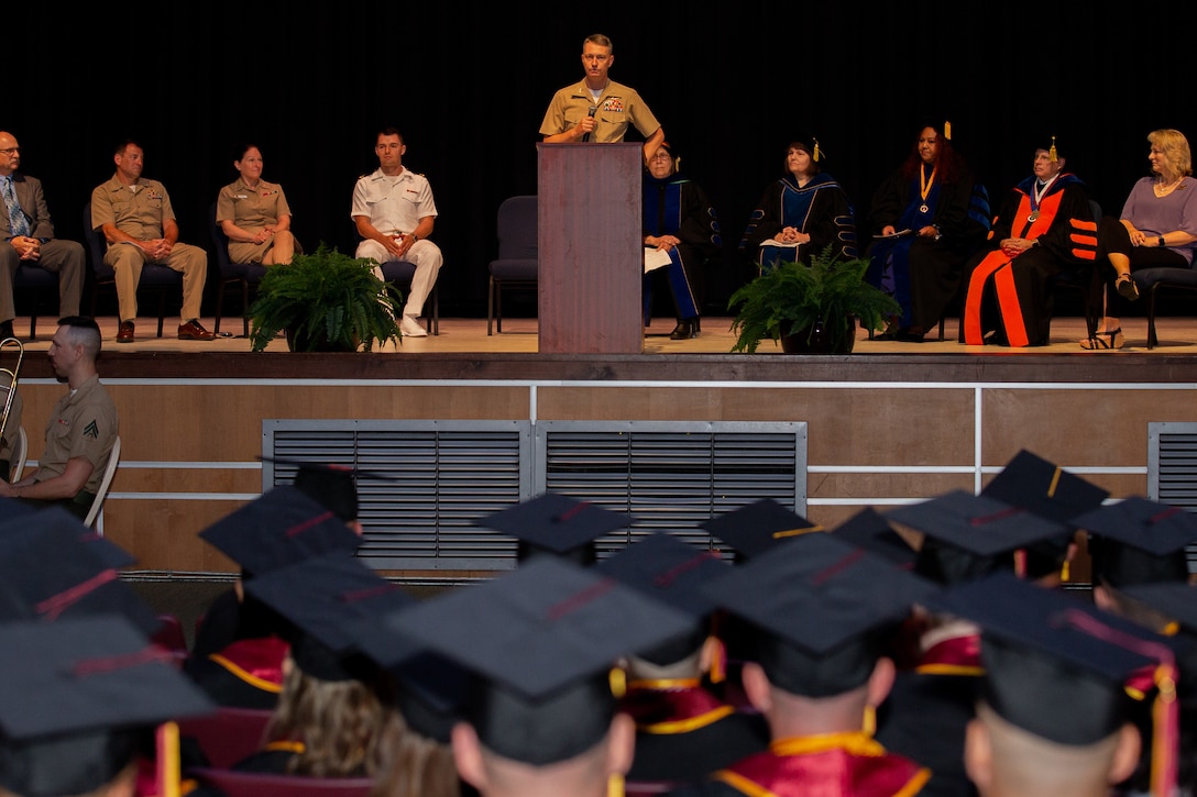 U.S. Marine Corps Col. Mikel Huber, commanding officer of Marine Corps Air Station (MCAS) Cherry Point, delivers a speech during the 46th Annual Voluntary Education Graduation Ceremony at Two Rivers Theater, MCAS Cherry Point, North Carolina, June 2, 2022. The goals of the voluntary education programs are to provide a broad range of personal and professional learning opportunities to improve the academic abilities of active-duty personnel to assist in their career progression and to generally strengthen the military community. (U.S. Marine Corps photo by Lance Cpl. Symira Bostic)