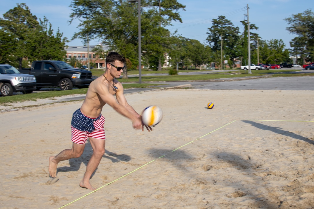 U.S. Marine Corps Capt. Matt Bender, of team Vertical Vibes, serves the volleyball during the championship match for the Top Gun: Maverick Madness Volleyball Tournament at the Roadhouse, Marine Corps Air Station Cherry Point, North Carolina, May 20, 2022. Marine Corps Community Services (MCCS) held a volleyball tournament to foster unit moral and friendly competition. T The winners of the competition received seats to a sneak-peek of Top Gun: Maverick. (U.S. Marine Corps photo by Sgt. Christian J. Lopez)