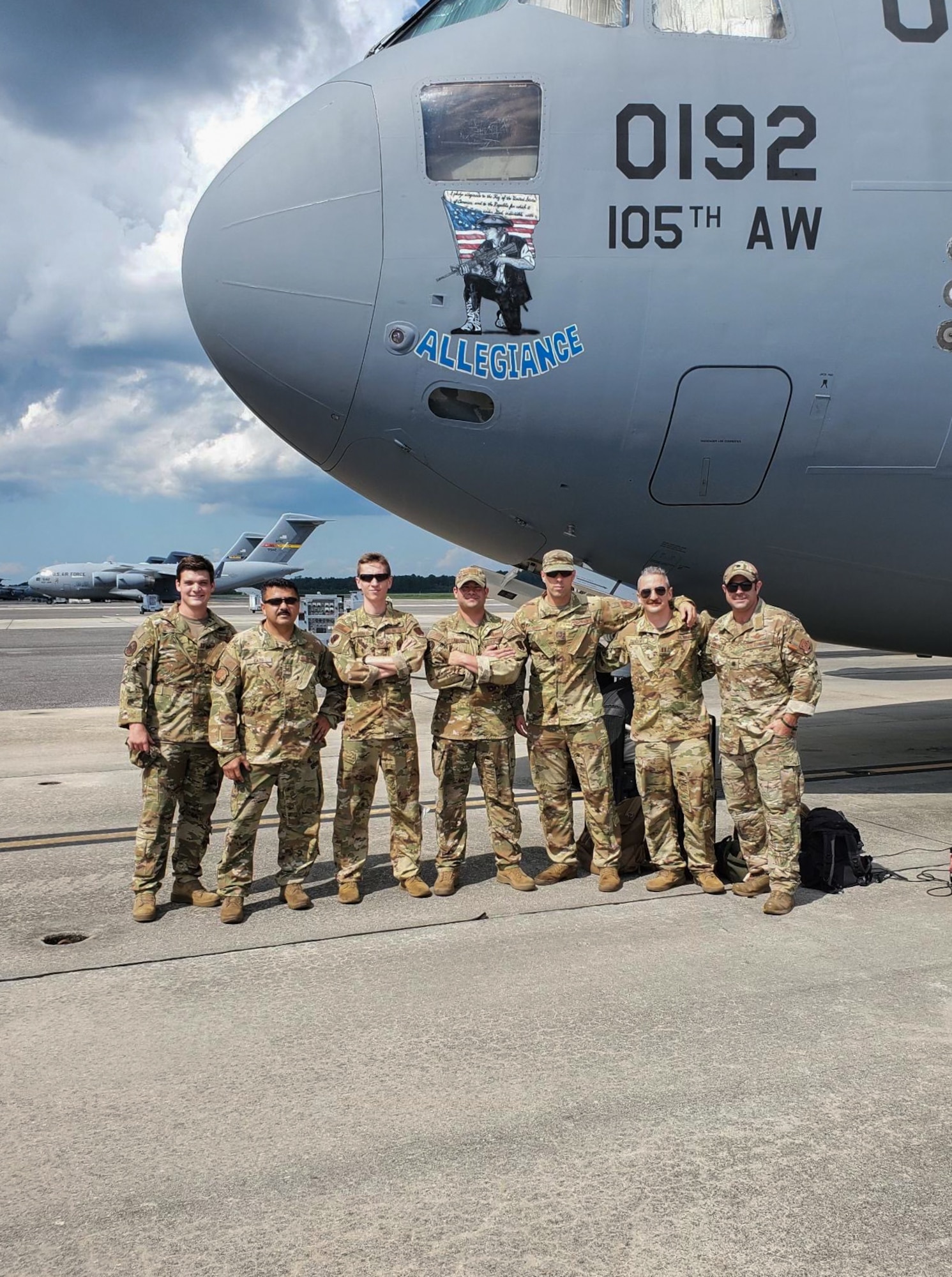 U.S. Airmen, crew members of Reach 824, 105th Airlift Wing, New York National Guard, pose for a photo in front of a C-17 Globemaster III at Joint Base Charleston in North Charleston, South Carolina, on Aug. 19, 2021. For their bravery and innovative thinking during the evacuation of Americans and Afghans from Kabul, Afghanistan in August 2021, the crew members were awarded either the Distinguished Flying Cross with Valor, the nation's highest honor for heroism during aerial operations, the Air Medal with Valor, or the Meritorious Service Medal. (Courtesy photo)