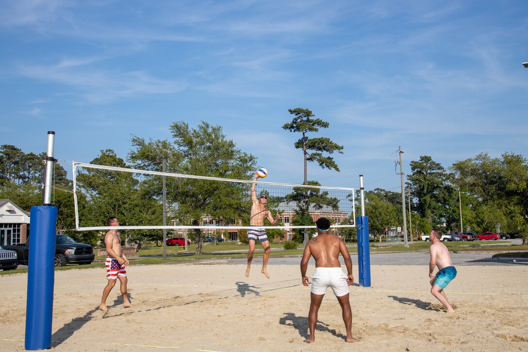 A Red Bulls team member spikes the volleyball over the net during the championship match for the Top Gun: Maverick Madness Volleyball Tournament at the Roadhouse, Marine Corps Air Station Cherry Point, North Carolina, May 20, 2022. Marine Corps Community Services held a volleyball tournament to foster unit moral and friendly competition. The winners of the competition received seats to a sneak-peek of Top Gun: Maverick. (U.S. Marine Corps photo by Sgt. Christian J. Lopez)