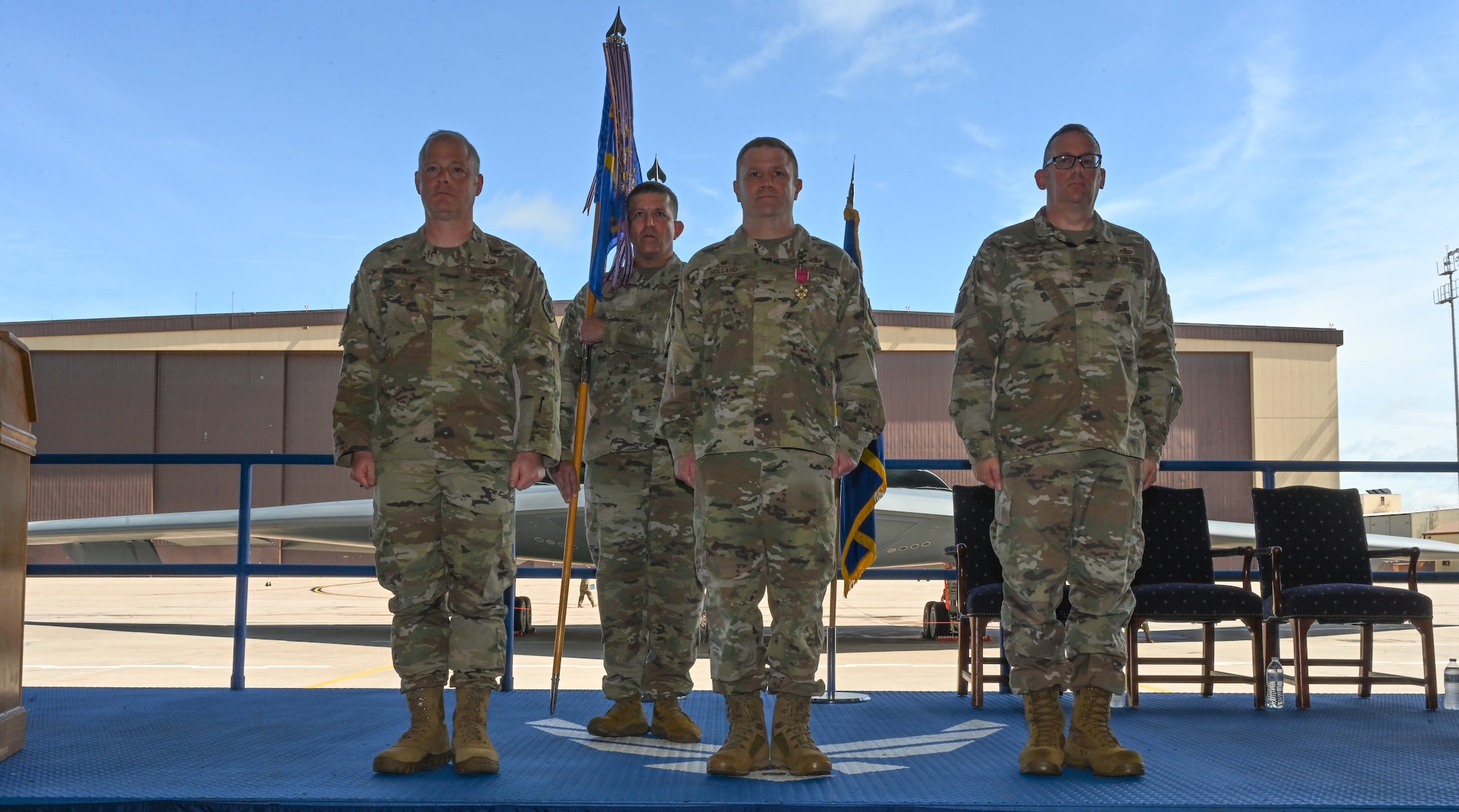 U.S. Air Force Col. Daniel Diehl, 509th Bomb Wing commander, presents U.S. Air Force Col. Jeffery Holland, 509th Maintenance Group commander, with the Legion of Merit Medal during the 509th MXG change of command ceremony on Whiteman Air Force Base, Missouri, June 6, 2022. Holland received the medal for his contributions to Team Whiteman and the 509th MXG during his command. (U.S. Air Force photo by Airman 1st Class Bryson Britt)