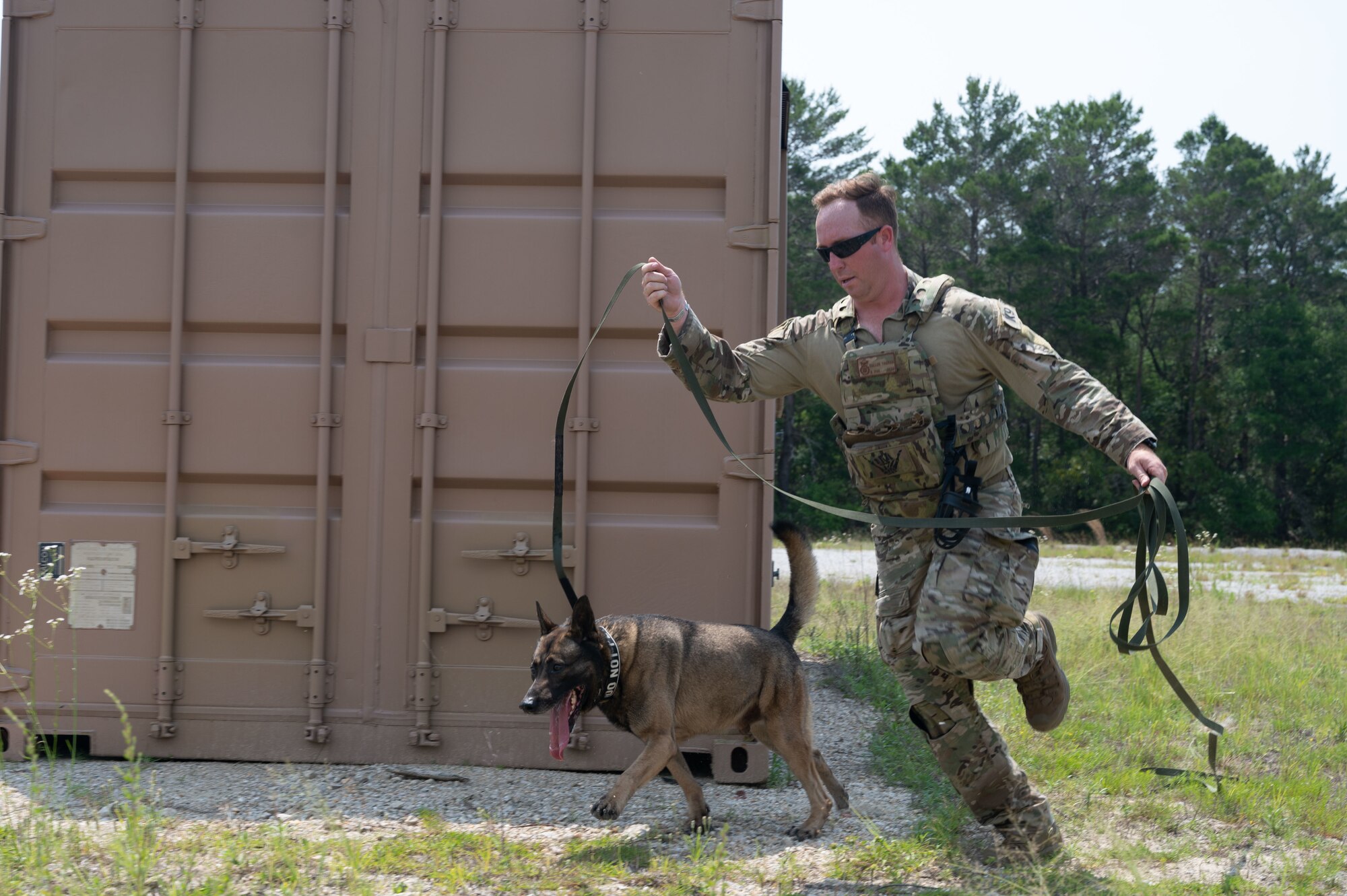U.S. Air Force Staff Sgt. Thomas Cullen, a military working dog handler from Tyndall Air Force Base, competes in a K9 competition during National Police Week on May 18, 2022, at Eglin Air Force Base.