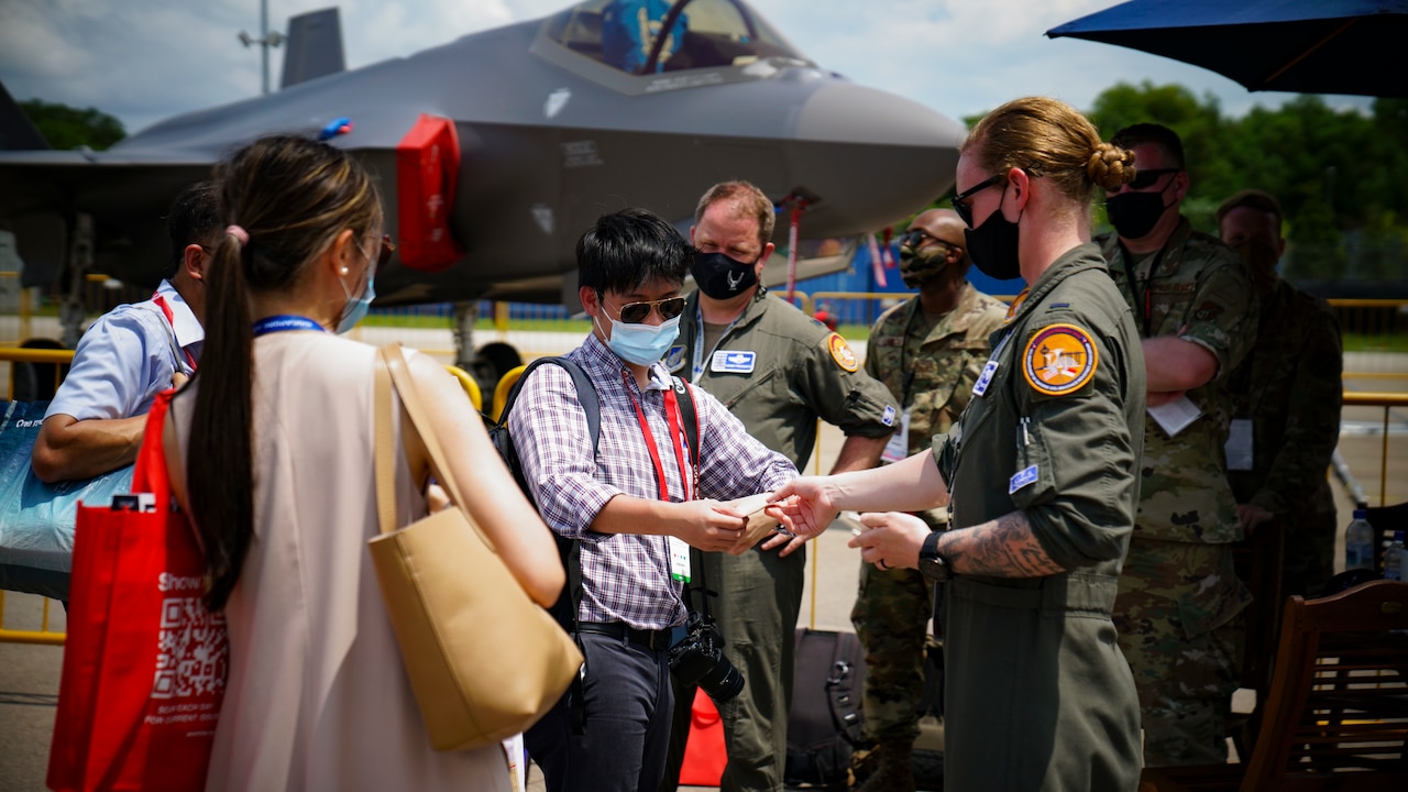 A pilot speaks with people.