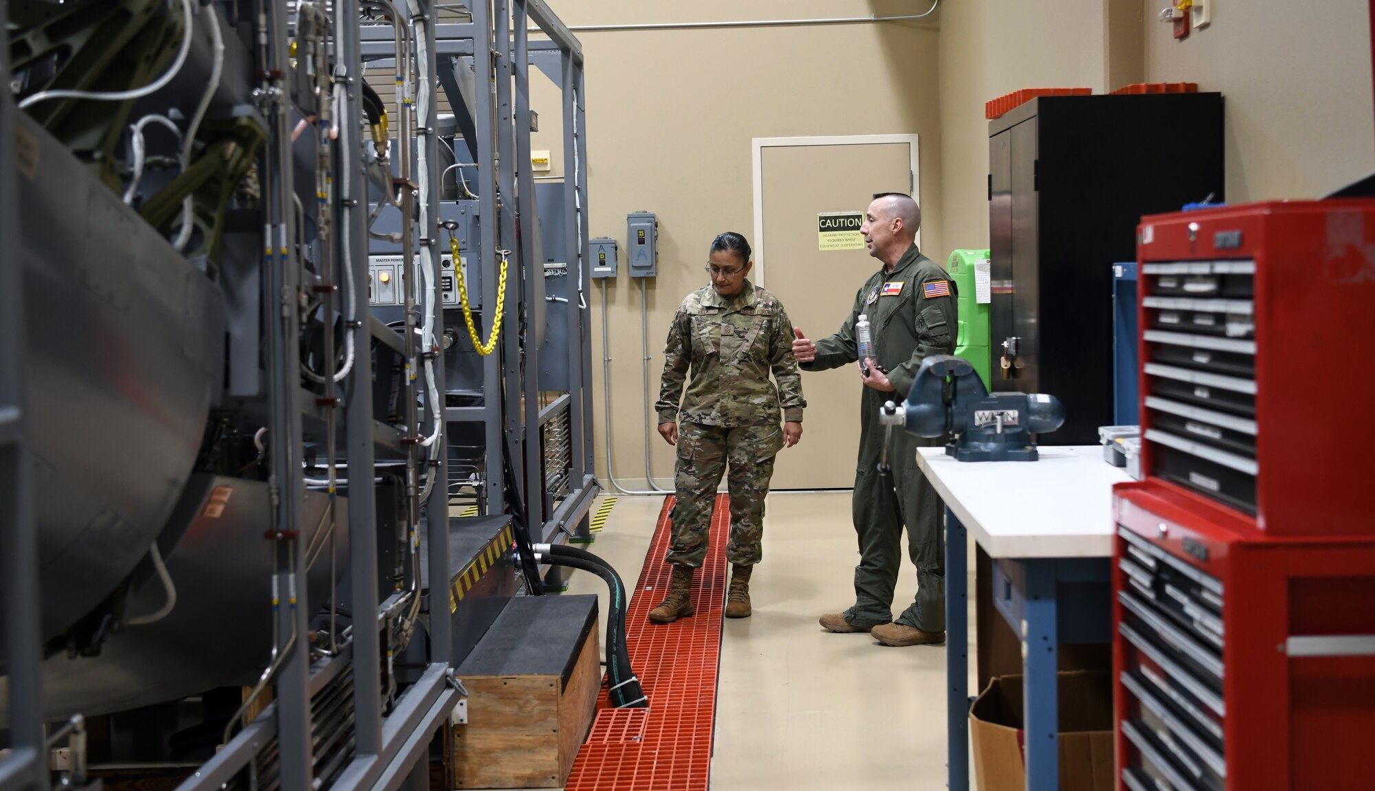 Chief Master Sgt. Cynthia Villa, 4th Air Force command chief, talks with Chief Master Sgt. David Walsh, 433rd Operations Group senior enlisted leader, about the C-5M Super Galaxy cargo door trainer units at the 733rd Training Squadron, Joint Base San Antonio-Lackland, Texas, June 3, 2022. The door trainers are scaled-down replicas of the aircraft’s cargo loading doors and ramps. (U.S. Air Force photo by Kristian Carter)