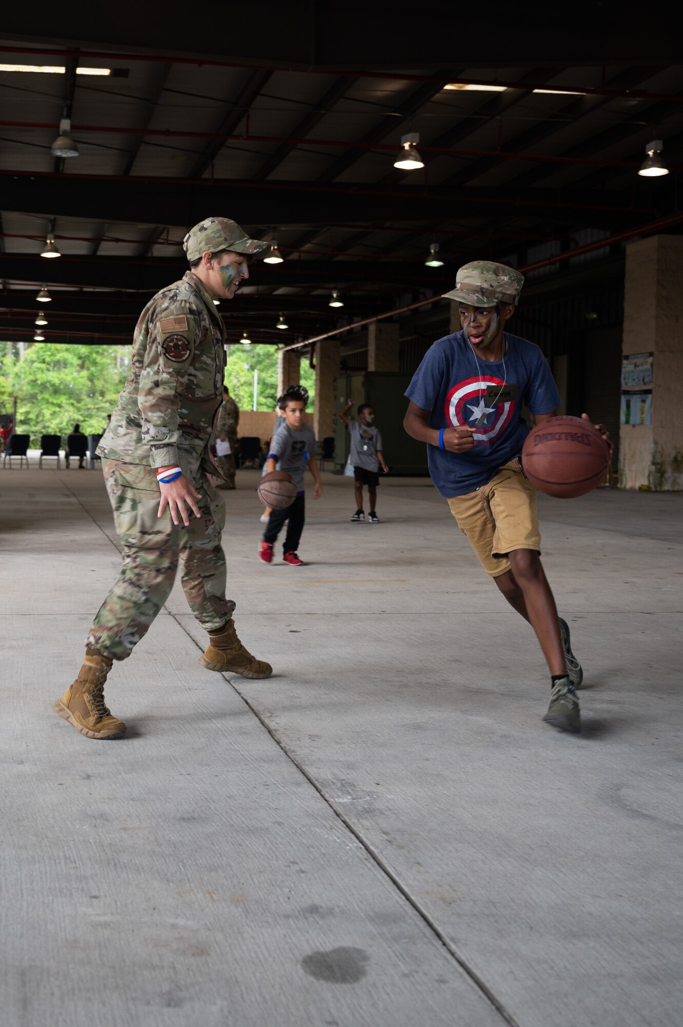 Children play basketball with Airman during Kids Understanding Deployment Operations April 30, 2022, at Hurlburt Field, Florida.