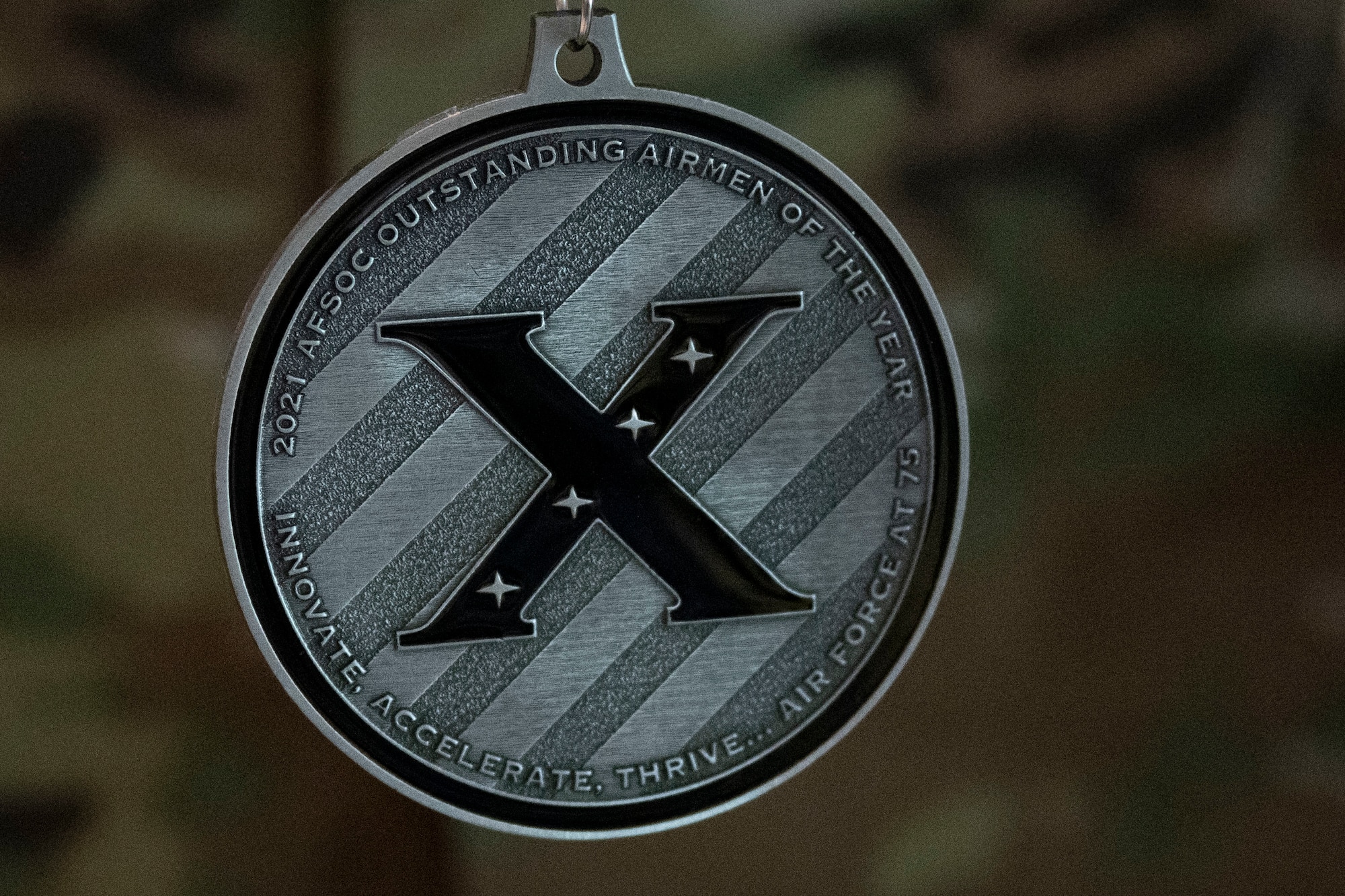 A 2021 Air Force Special Operations Command Outstanding Airman of the Year award winner wears a medallion honoring their accomplishments during a tour May 11, 2022 at Hurlburt Field, Florida.