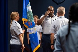 Col. James "Cobra" Finlayson renders a salute to Lt. Gen. Timothy Haugh, 16th Air Force Commander, upon assuming command of the Air Force Technical Applications Center, Patrick Space Force Base, Fla., June 2, 2022 as outgoing commander, Col. Katharine Branson, relinquishes command.  Also pictured is Chief Master Sgt. Amy Long, AFTAC command chief and guidon bearer for the ceremony. (U.S. Air Force photo by Matthew S. Jurgens)
