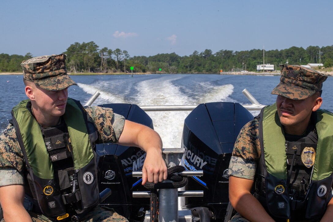 U.S. Marine Corps Lance Cpl. Gustaf Redin (left), and Lance Cpl. Francisco Garza, military policemen with the Provost Marshal’s Office, Marine Corps Air Station (MCAS) Cherry Point, patrol the waterways surrounding MCAS Cherry Point, North Carolina, June 2, 2022. Routine patrols are necessary for security, readiness or response in the event of increased Force Protection Conditions. (U.S. Marine Corps photo by Lance Cpl. Lauralle Walker)