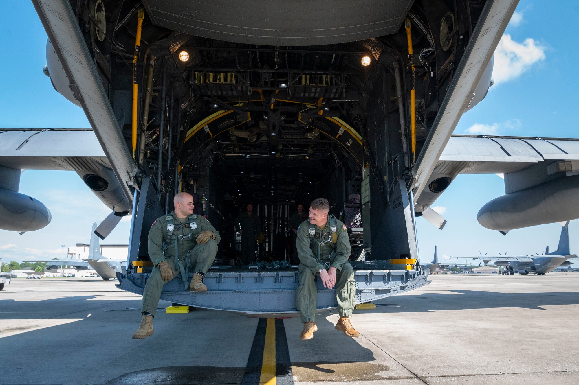 U.S. Air Force Master Sgt. Adrian Garcia, left, 19th Special Operations Squadron operations superintendent, and U.S. Air Force Master Sgt. Frank Veres, right, 492nd Special Operations Training Support Squadron MC-130H program manager, check harness lengths for the MC-130H Combat Talon II final flight under the 492nd Special Operations Wing at Hurlburt Field, Florida, May 31, 2022.