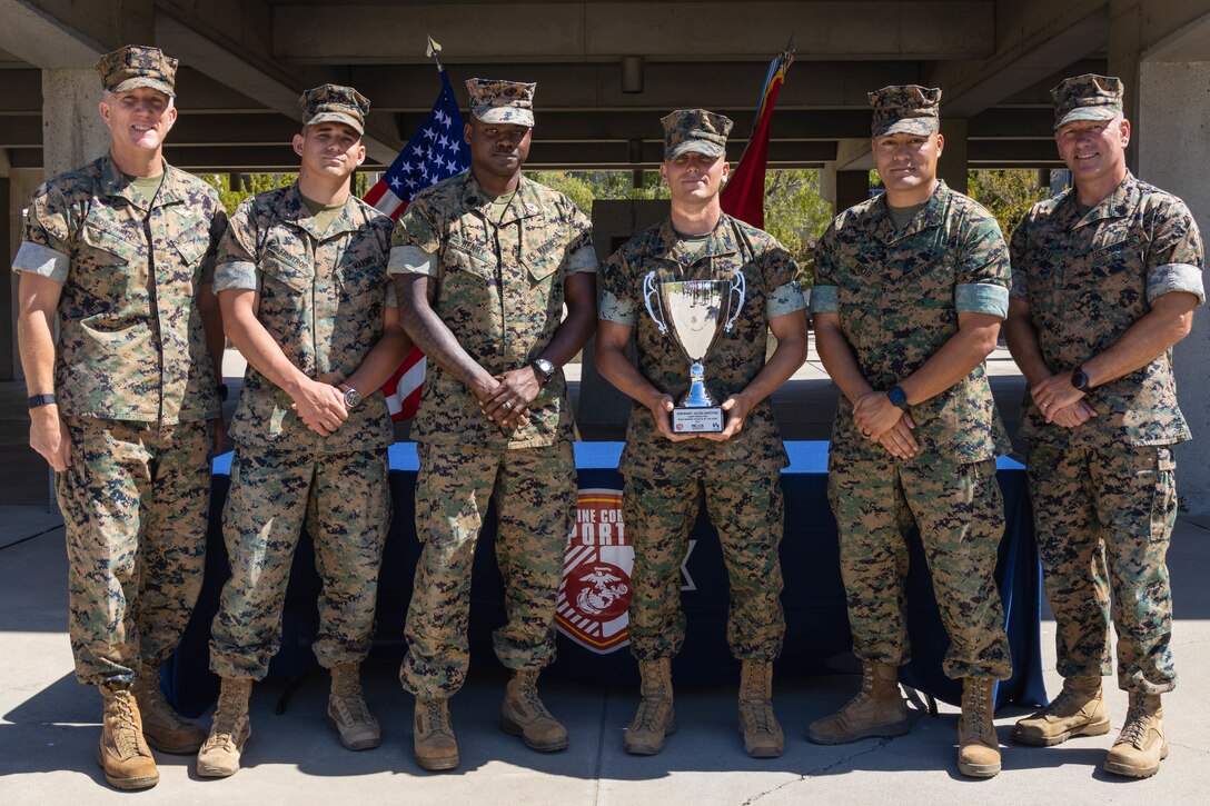 U.S. Marine Sgt.  Zarzycki, center right, the heavy equipment chief with Combat Logistics Battalion 13, Combat Logistics Regiment 17, 1st Marine Logistics Group, poses with his leadership following the Camp Pendleton Male Marine Athlete of the Year award ceremony on Marine Corps Base Camp Pendleton, California, May 31, 2022. Zarzycki participated in the Ironman 70.3 World Championship and a 32.5-mile ultramarathon, and has completed smaller races, such as half marathons and various triathlons. (U.S. Marine Corps photo by Lance Cpl. Mhecaela J. Watts)