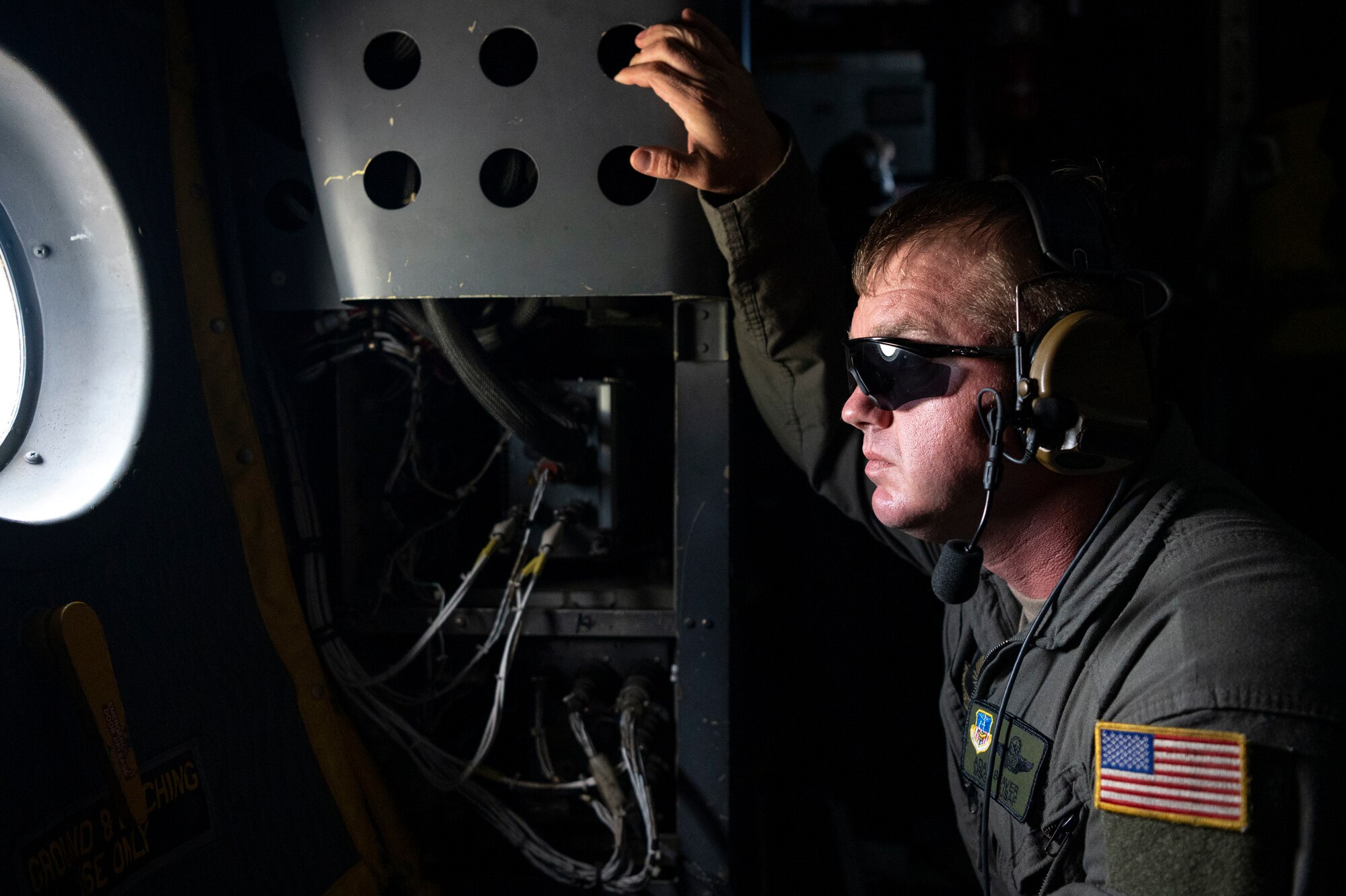 U.S. Air Force Master Sgt. Adam Beaver, the 19th Special Operations Squadron mobility section supervisor, looks out the window of an MC-130H Combat Talon II during its final flight under the 492nd Special Operations Wing at Hurlburt Field, Florida, May 31, 2022.