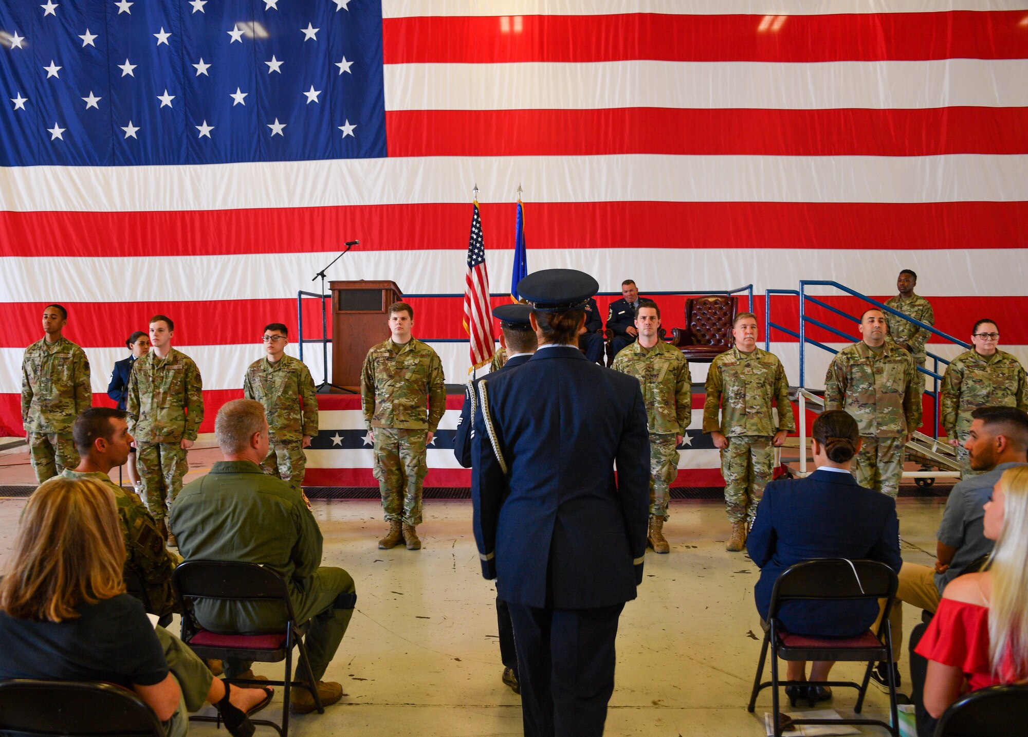 Dyess Air Force Base Honor Guard members prepare to fold the flag during a retirement ceremony at Naval Air Station Joint Reserve Base Fort Worth, Texas, June 4, 2022. Chief Master Sgt. Mclain received his flag after honorably serving for 27 years. (U.S. Air Force photo by Staff Sgt. Nije Hightower)