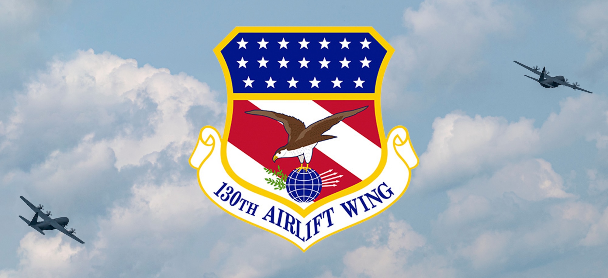Two C-130 J-30 fly over McLaughlin Air National Guard Base with the unit shield of the the 130th Airlift Wing overlaid.