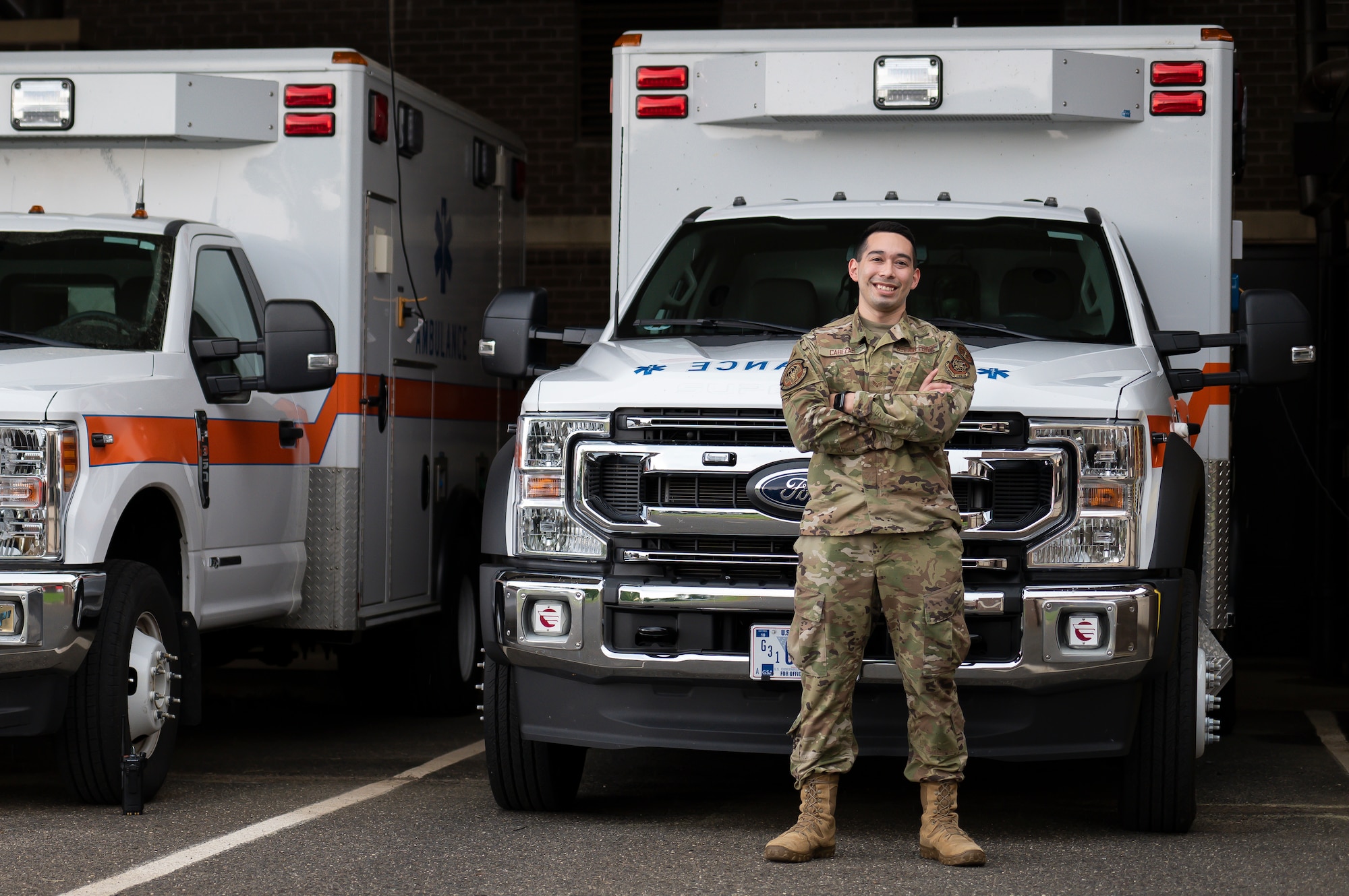 U.S. Air Force Senior Airman Ricardo Cabezas, a medic from the 87th Healthcare Operations Squadron, poses for a photo in front of an ambulance on Joint Base McGuire-Dix-Lakehurst, N.J., June 2, 2022.