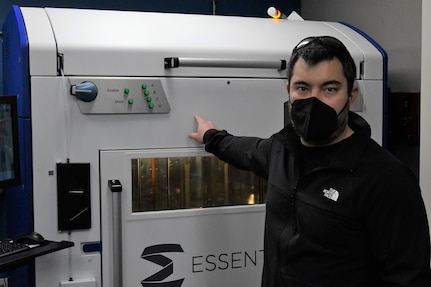 IMAGE: Tim Peng, lead mechanical engineer at Naval Surface Warfare Center Dahlgren Division, shows off an Essentium HSE 280i HT 3D printer. Peng leads a team of engineers in Additive Manufacturing.