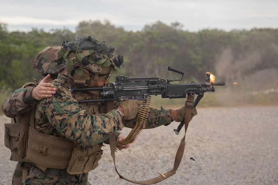 A U.S. Marine with 3rd Battalion, 6th Marine Regiment, 2nd Marine Division, and a French Foreign  Legionnaire with 2nd Regiment, fires the FN Minimi at Nimes, France, May, 24, 2022. This was part of a bilateral training event with the French Foreign Legion that challenged the forces with physical and tactical training, as well as provided the opportunity to exchange knowledge and strengthen bonds.