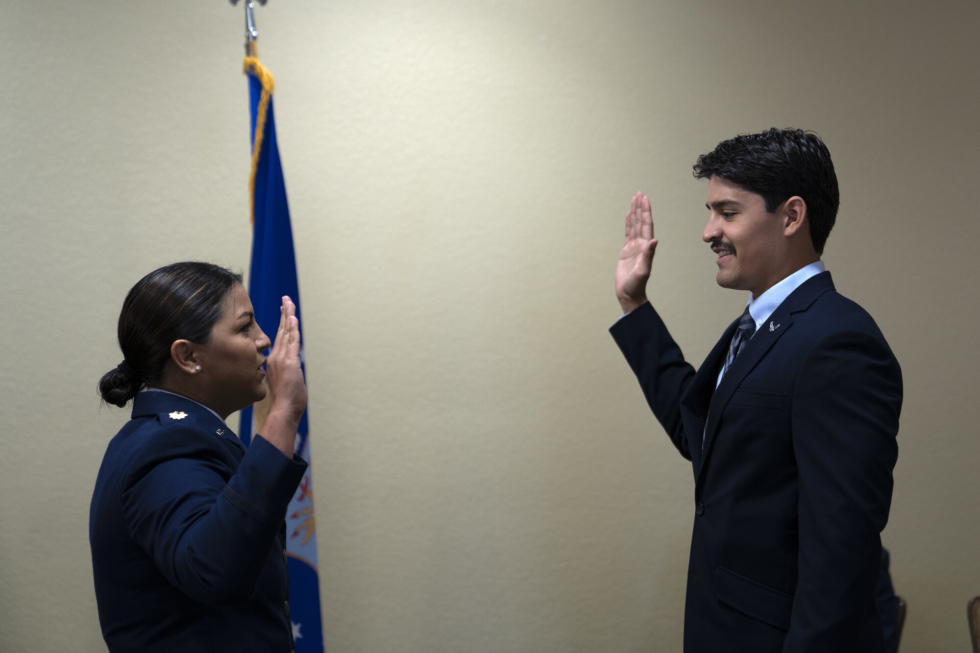 U.S. Air Force Maj. Amanda Delgado, 81st Surgical Squadron OBGYN physician, gives the oath of office to 2nd Lt. Jose Delgado Jr., Texas Rio Grande Valley school of medicine student, at Keesler Air Force Base, Mississippi, June 6, 2022. Amanda shared her promotion ceremony with her younger brother with their father there to witness. (U.S Air Force photo by Airman 1st Class Trenten Walters)