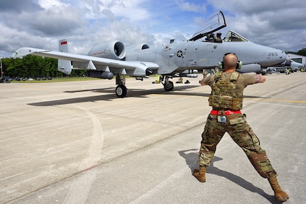 A U.S. Air Force Airman from the 127th Aircraft Maintenance Squadron, Selfridge Air National Guard Base, Mich., performs Agile Combat Employment training while marshaling an A-10 Thunderbolt II in an Integrated Combat Turn during Agile Rage 22, June 7, 2022.