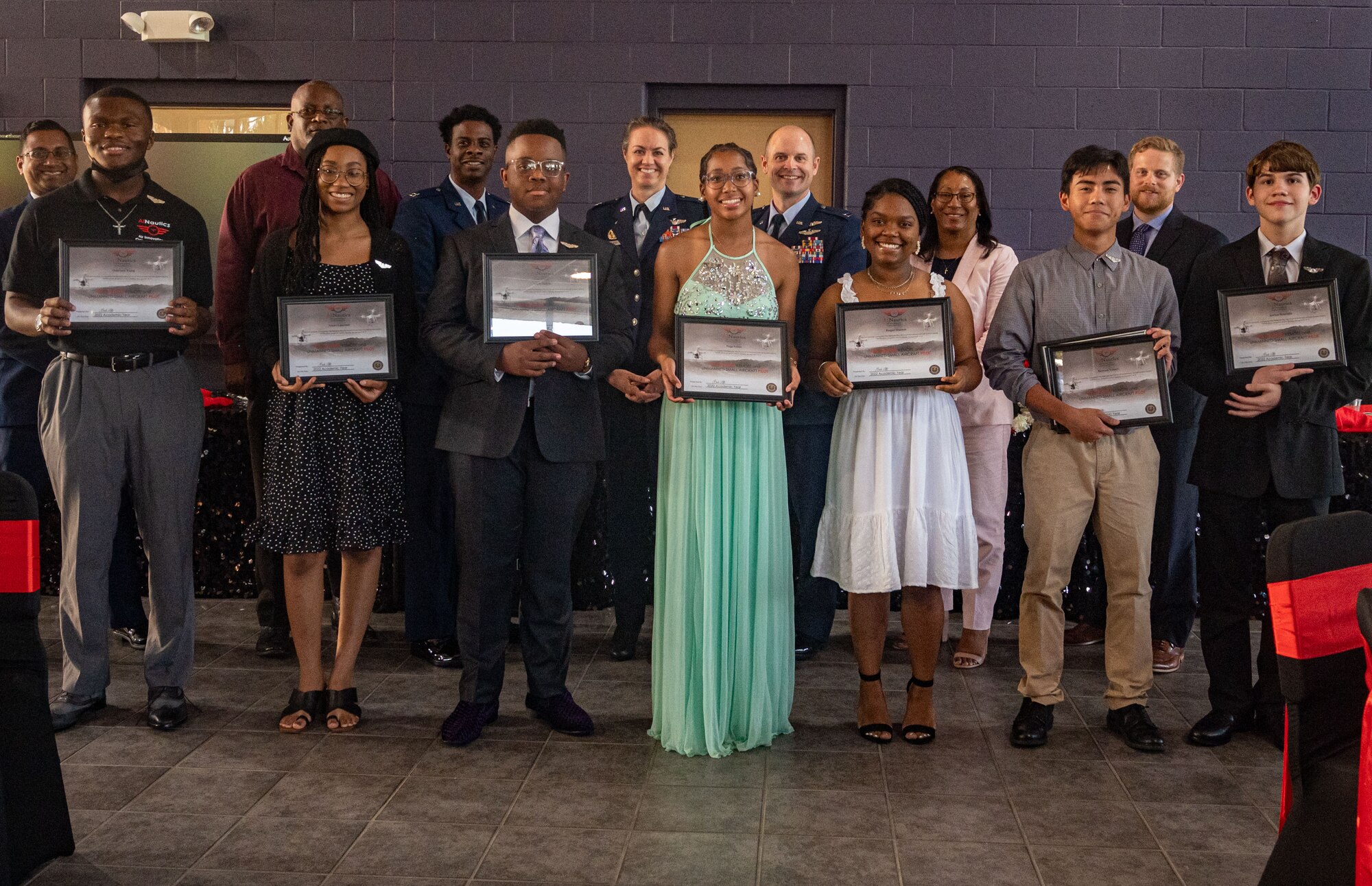 A photo of people holding certificates.