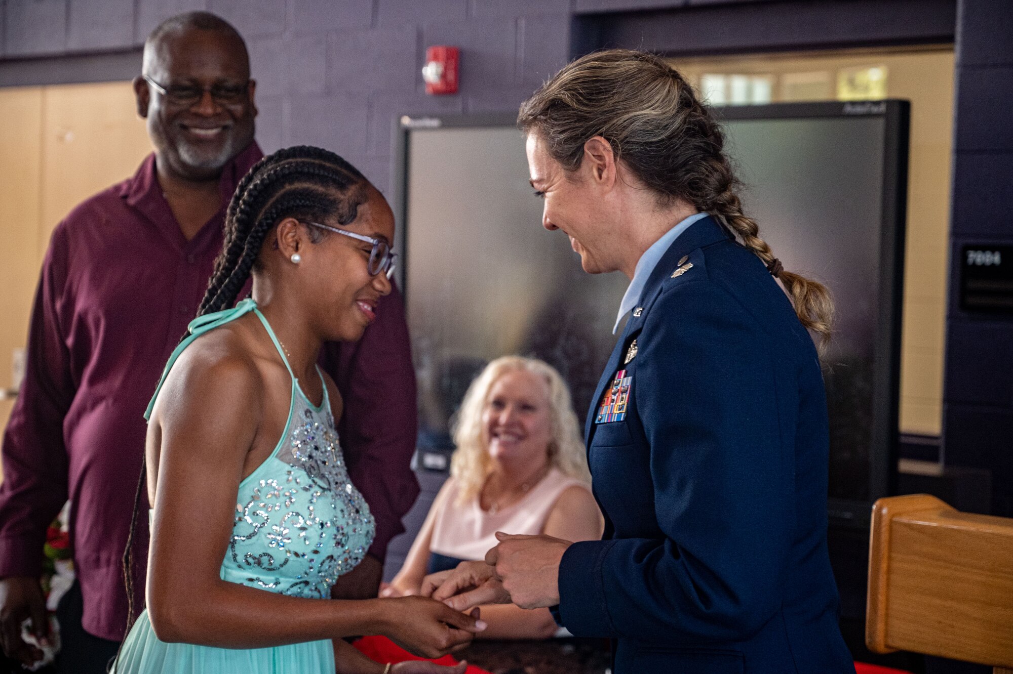 A photo of an Air Force member shaking hands with a student.