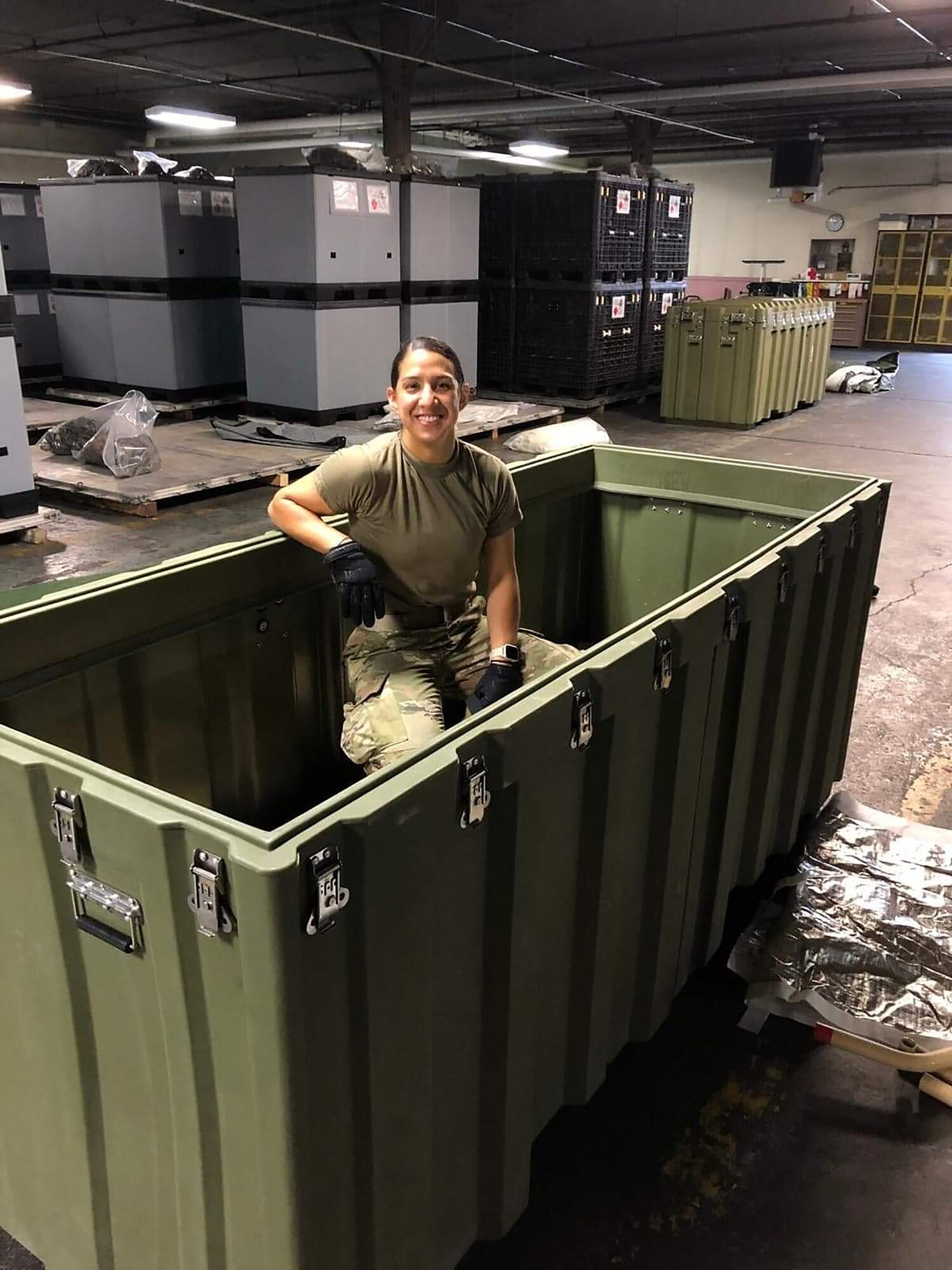 Staff Sgt. Jeanette Salgado, 445th Aeromedical Staging Squadron medical material journeyman, empties a bin of equipment for a week-long aeromedical and global patient movement exercise, Ultimate Caduceus, held at Wright-Patterson Air Force Base, Ohio, April 28, 2021.