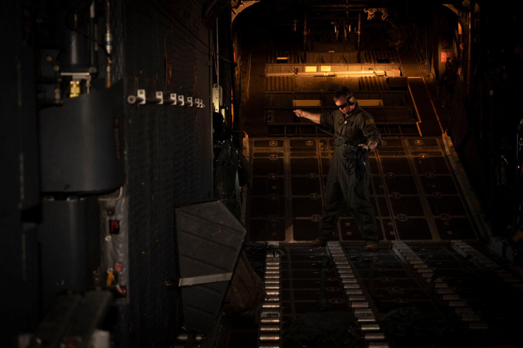 U.S. Air Force Master Sgt. Adam Beaver, the 19th Special Operations Squadron mobility section supervisor, untangles a cord before the final MC-130H Combat Talon II flight under the 492nd Special Operations Wing at Hurlburt Field, Florida, May 31, 2022.