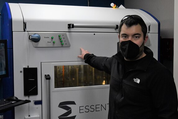 IMAGE: Tim Peng, lead mechanical engineer at Naval Surface Warfare Center Dahlgren Division, shows off an Essentium HSE 280i HT 3D printer. Peng leads a team of engineers in Additive Manufacturing.