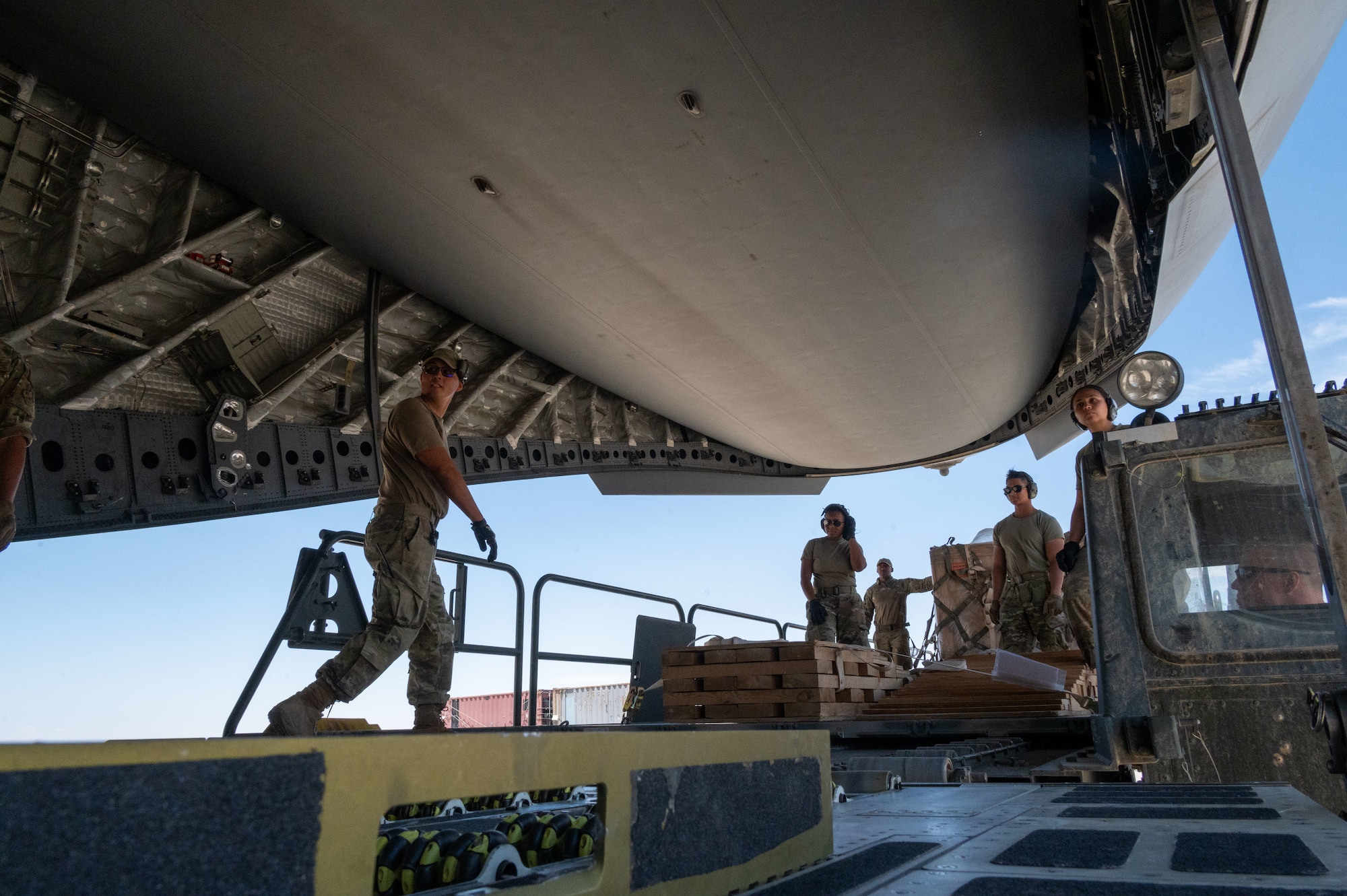 332d Expeditionary Logistics Readiness Squadron Aerial Port Airmen prepare to load cargo into a C-17 Globemaster III aircraft at an undisclosed location in Southwest Asia, May 7, 2022. Working in concert to coordinate movement of aircraft, passengers, equipment, and everything else requiring air travel, the 332d ELRS’s Aerial Port enables the 332d Air Expeditionary Wing to continue to provide regional security throughout its area of responsibility.