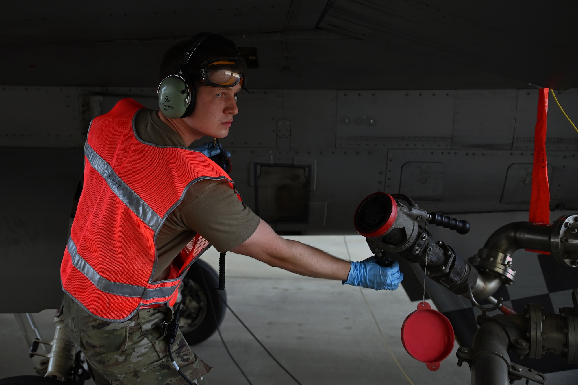 Senior Airman Thoburn Freeman, 36th Fighter Generation Squadron aircraft electrical and environmental systems technician, prepares to connect a fuel hose to a 36th Fighter Squadron F-16 Fighting Falcon on Suwon Air Base, Republic of Korea, June 2, 2022. Thorburn conducted hot-pit refueling, whereby the aircraft remains running allowing an expedited turn time. (U.S. Air Force photo by Master Sgt. Rachelle Morris)