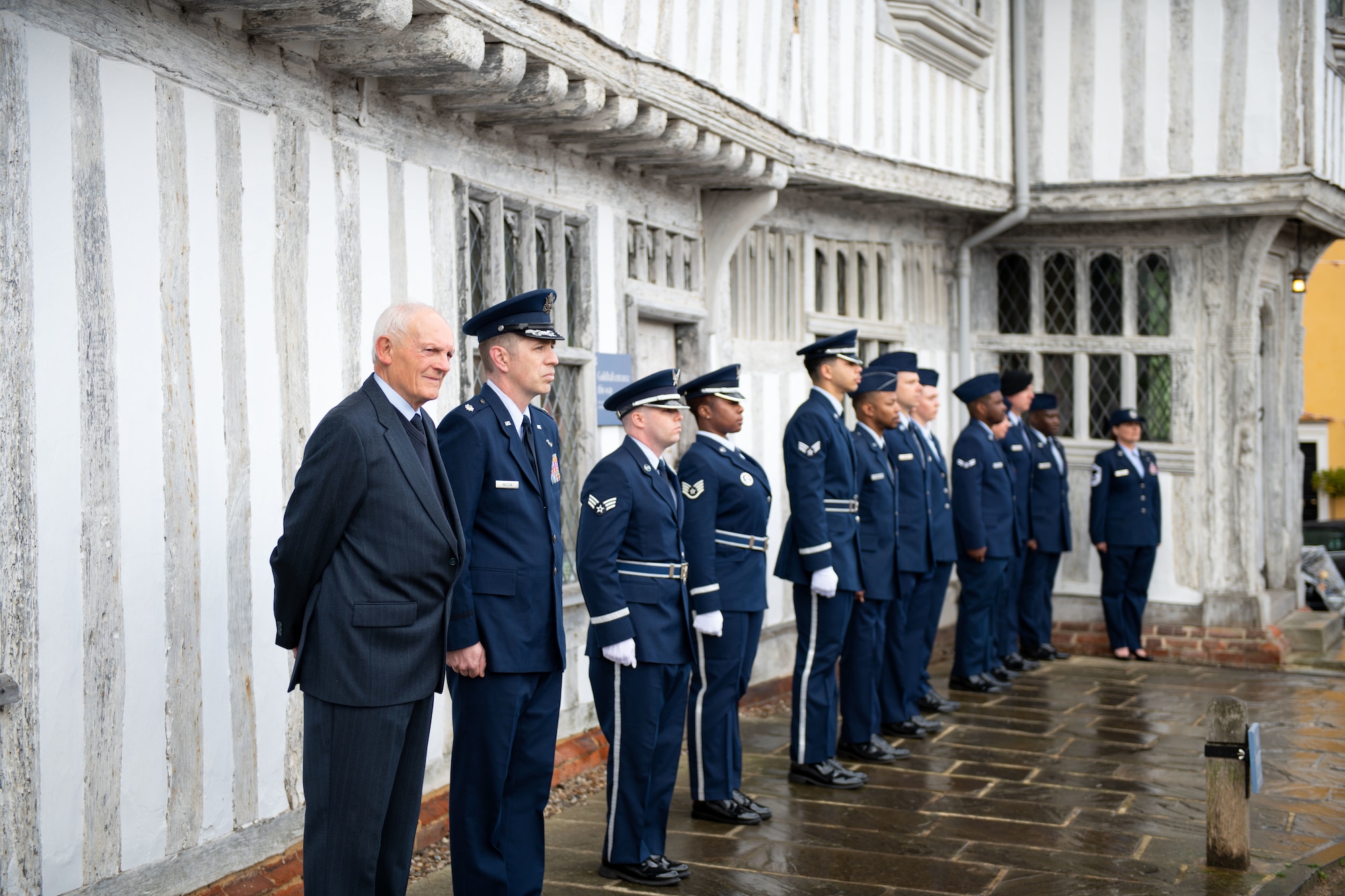 Personnel from RAF Mildenhall stand at attention alongside the Lavenham and Sudbury community during the remembrance ceremony held in Lavenham Market Place, England, May 29, 2022.