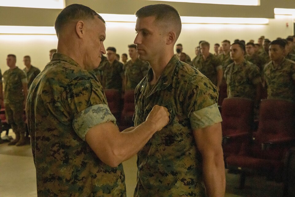 Brig. Gen. Brian Wolford, the 3rd Marine Logistics Group commanding general, awards the Navy and Marine Corps Medal to 1st Lt. Steven Ladine, a logistics officer with 9th Engineer Support Battalion, 3rd MLG, on Camp Hansen, Okinawa, Japan, June 7, 2022. LaDine was awarded the Navy and Marine Corps Medal for heroism for rescuing a civilian from drowning off the coast of Nagahama Beach in May 2021.