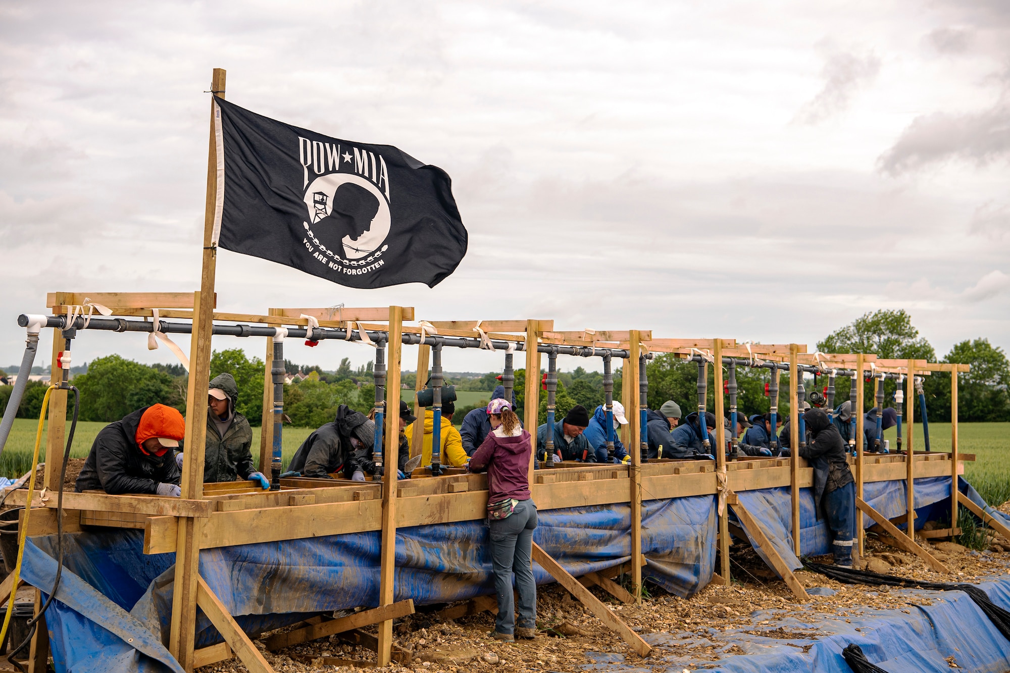 POW/MIA Accounting Agency members, as well as volunteers from bases in England, sift through dirt near London-Stansted, England, May 25, 2022. The team was conducting a recovery operation for the remains of a U.S. service member whose plane crashed there in 1944 during World War II. (U.S. Air Force photo by Staff Sgt. Eugene Oliver)