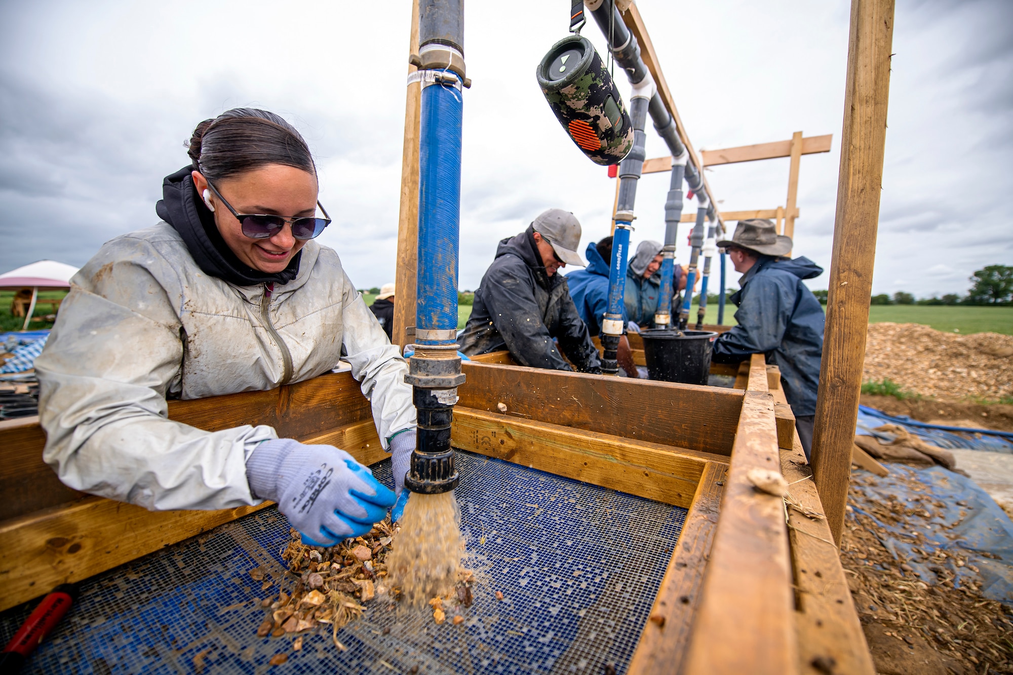 POW/MIA Accounting Agency members, as well as volunteers from bases in England, sift through dirt near London-Stansted, England, May 25, 2022. The team was conducting a recovery operation for the remains of a U.S. service member whose plane crashed there in 1944 during World War II. (U.S. Air Force photo by Staff Sgt. Eugene Oliver)