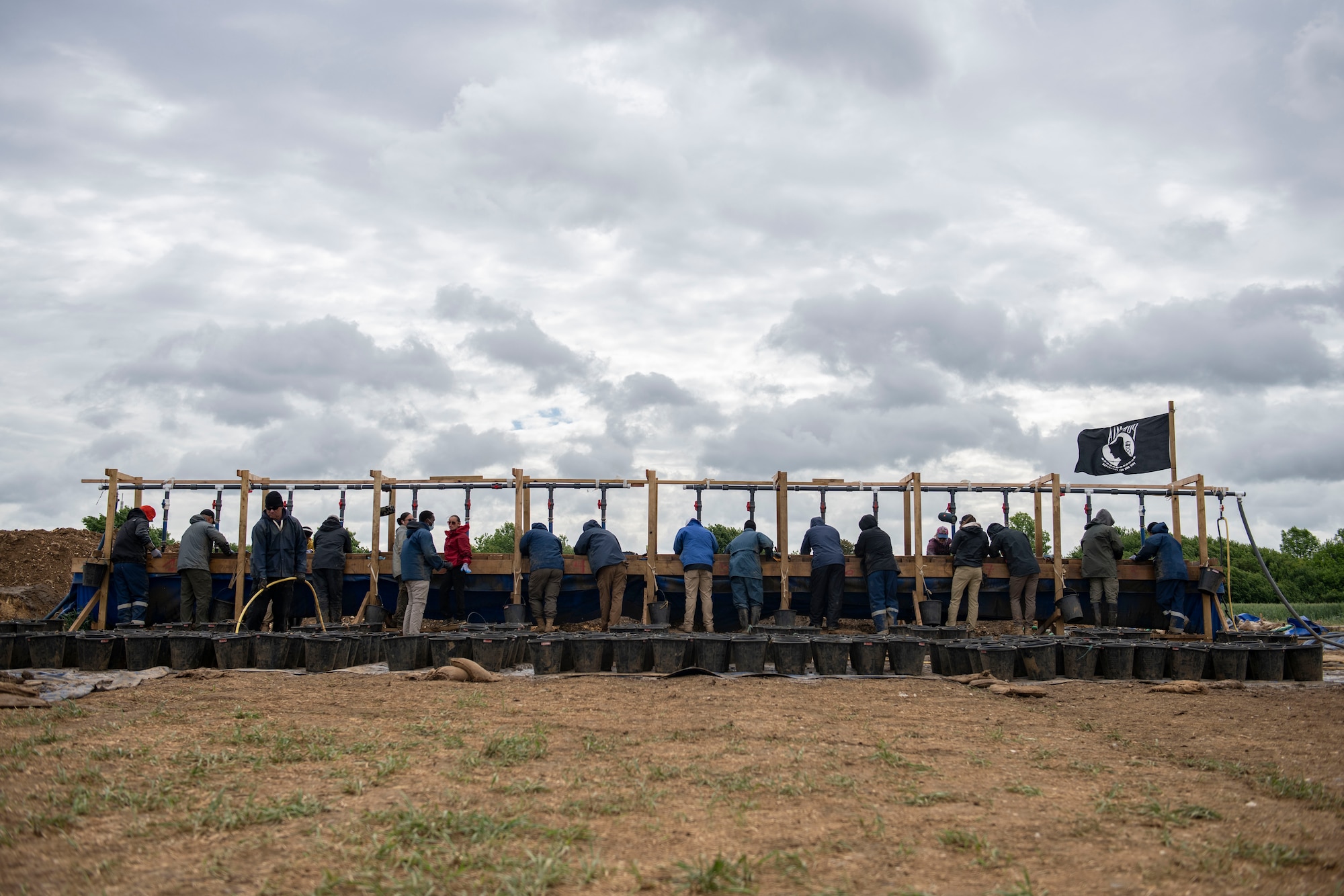 POW/MIA Accounting Agency members, as well as volunteers from bases in England, sift through dirt near London-Stansted, England, May 25, 2022. They were conducting a recovery operation for the remains of a U.S. service member whose plane crashed there in 1944. (U.S. Air Force photo by Senior Airman Jason W. Cochran)